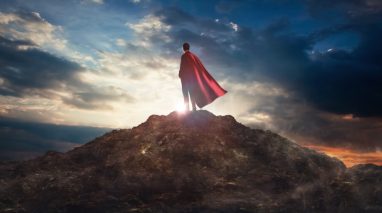 Business stands protected with business insurance and wears a cape to show it.