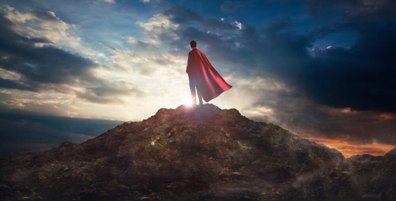 Business stands protected with business insurance and wears a cape to show it.