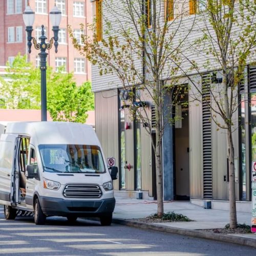 vf-when-your-business-wheels-need-more-than-just-a-tune-up-commercial-auto-insurance-101-1 Delivery van in front of building in downtown, commercial auto insurance in Washington needed.
