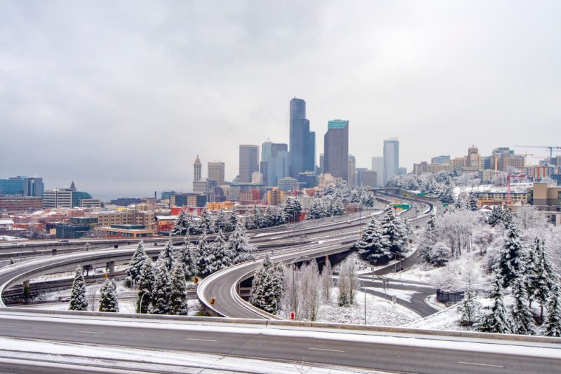 Downtown Seattle is covered in snow on a cloudy winter day, highlighting how harsh weather makes commercial auto insurance essential for businesses on the road