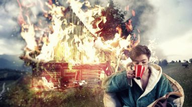 Man drinks coffee and reads a book while his house burns in the background, symbolizing insurance mistakes Washington.