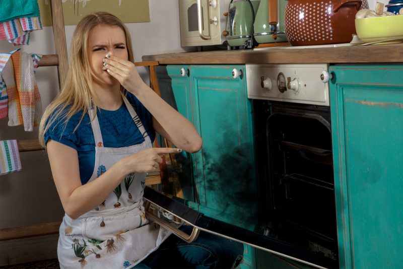 Young girl burning cake.
