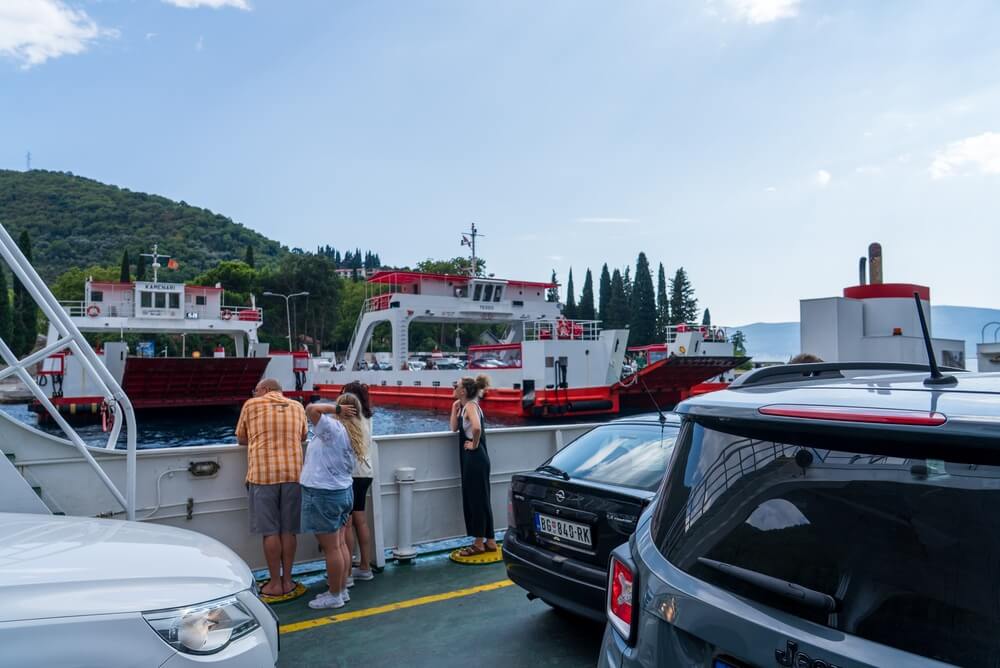 Vehicles and passengers aboard a ferry illustrating the risk of car damage while parked on a ferry.