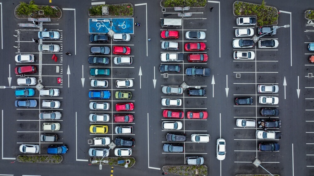 Parking lot danger and car insurance risks in a crowded parking area with multiple vehicles.
